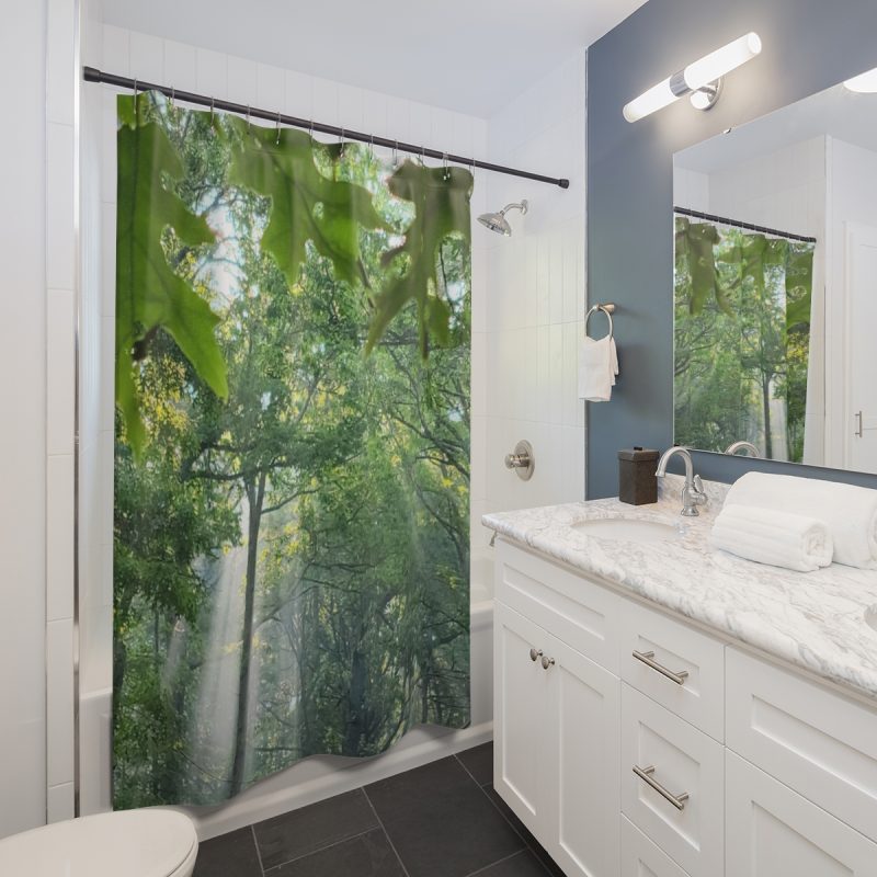 shower curtain with a green scenic wooded area that has sunlight peeking thru the leafs